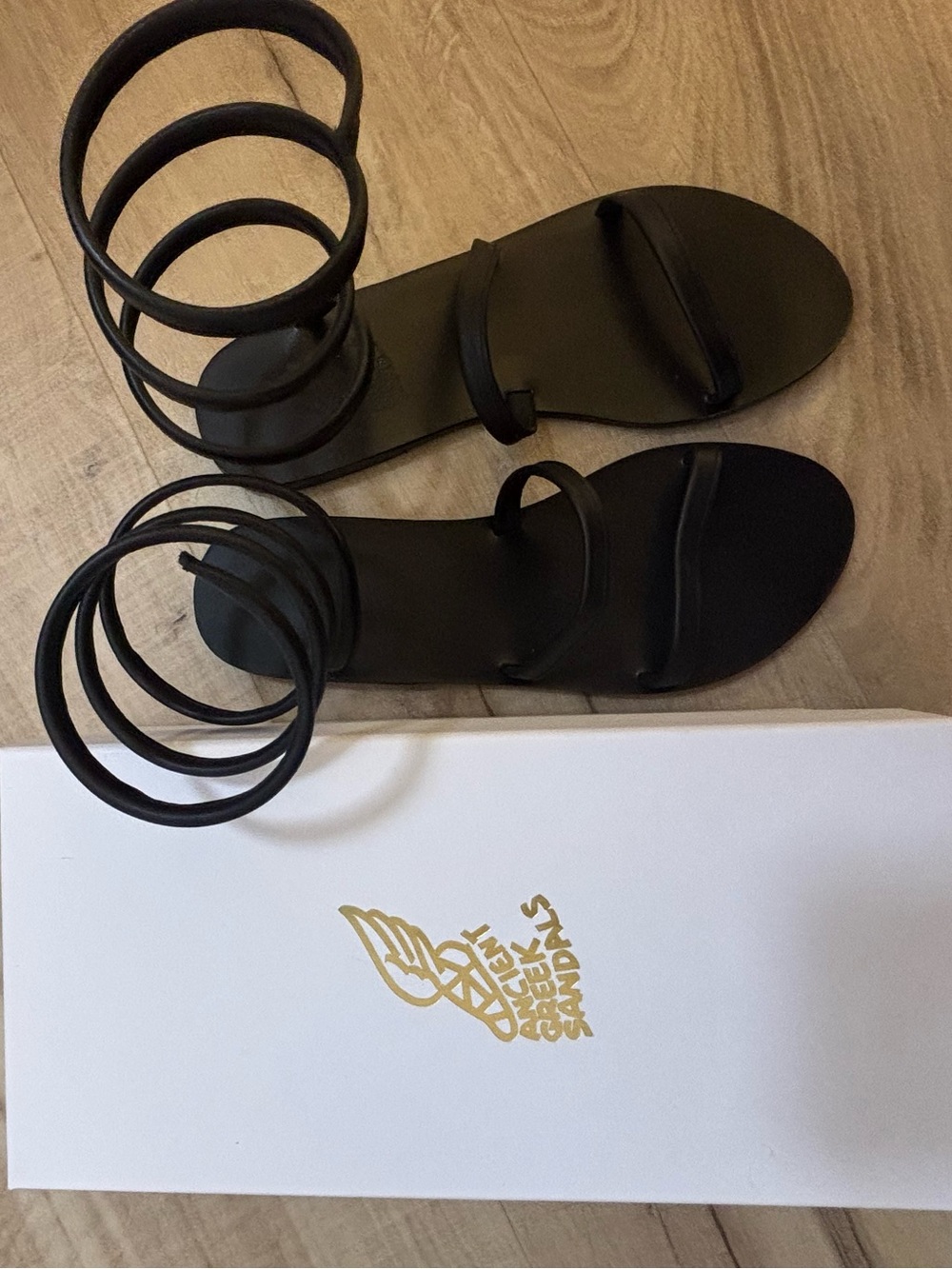 Ancient Greek Sandals Black Spiral-Strap Sandal Box Illustration